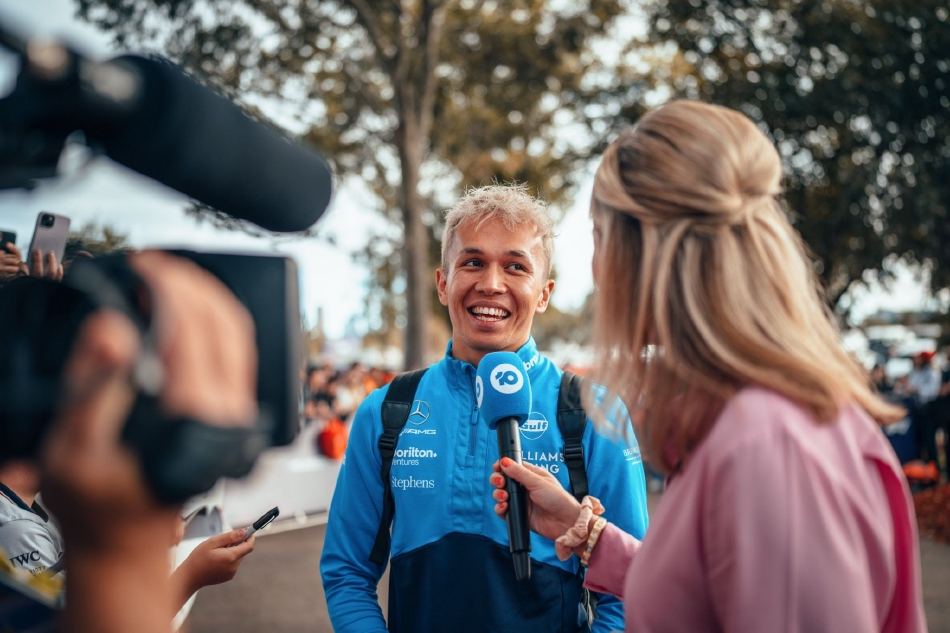法拉利车队的查尔斯·勒克莱尔驾驶红色赛车在弯道中划出优美的弧线，身后是墨尔本阿尔伯特公园宁静的湖泊，速度与美景交织。