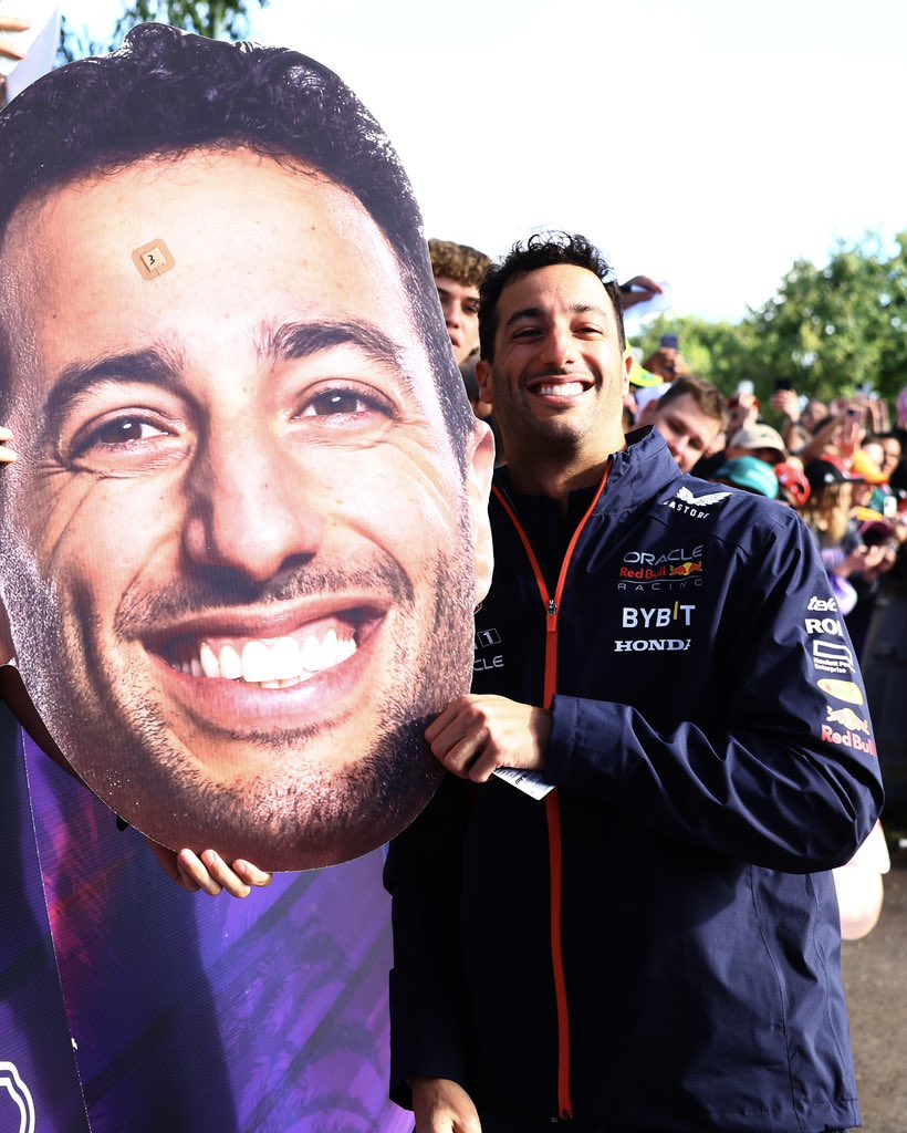 中国车手周冠宇在阿尔法·罗密欧赛车座舱内全神贯注，眼神坚毅，正在与工程师沟通复杂的赛道与赛车数据。