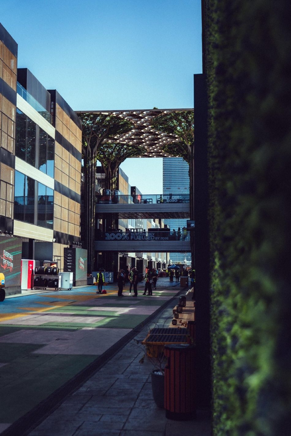 身着各色车队服装的技师们穿梭于维修区内,形成一道流动的风景线,背景中整齐排列的轮胎墙预示着即将到来的高强度消耗战。