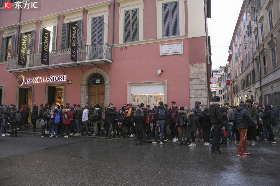 罗马少年扎尼奥洛低头为球迷签名，身旁美女安静注视，画面温馨如同晨曦中的台伯河