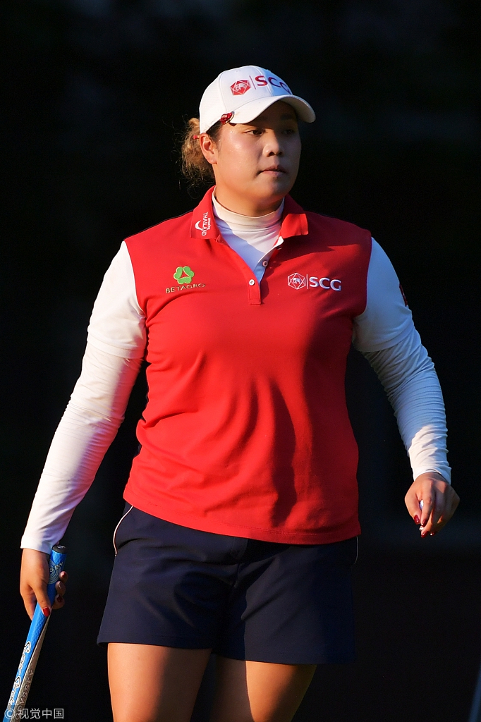 阿瑞雅挥杆完成沙坑救球的瞬间，沙砾飞扬，她的身体重心完全转移，展现出强大的核心力量与动作控制。