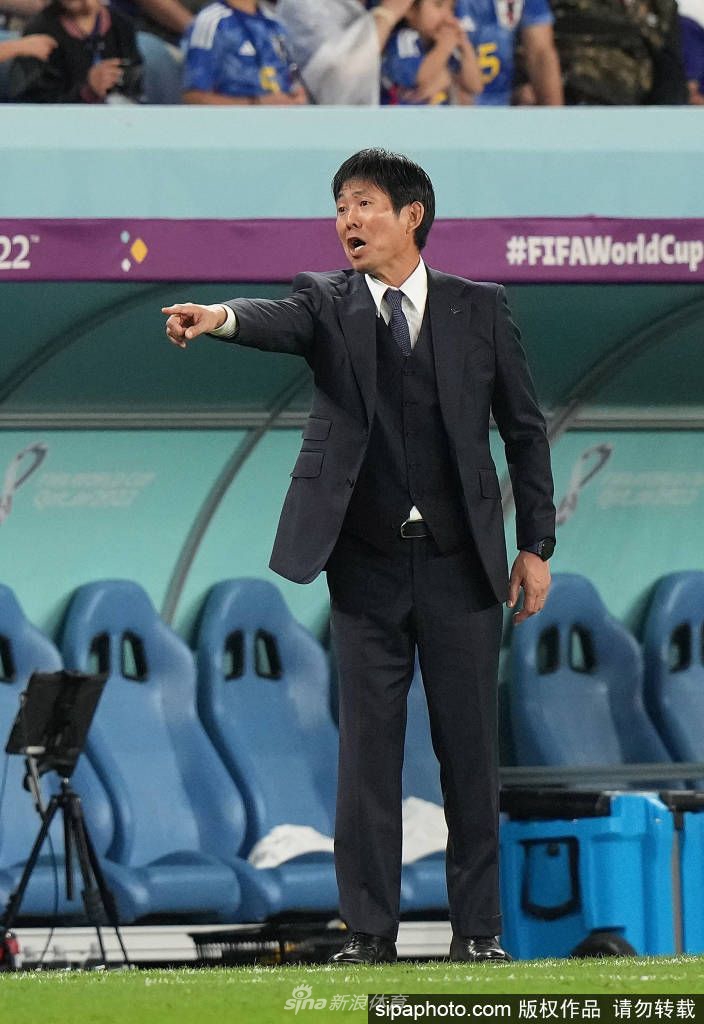 森保一与日本队球员围聚一起进行战术讨论，团队氛围专注而团结，展现出强大的凝聚力