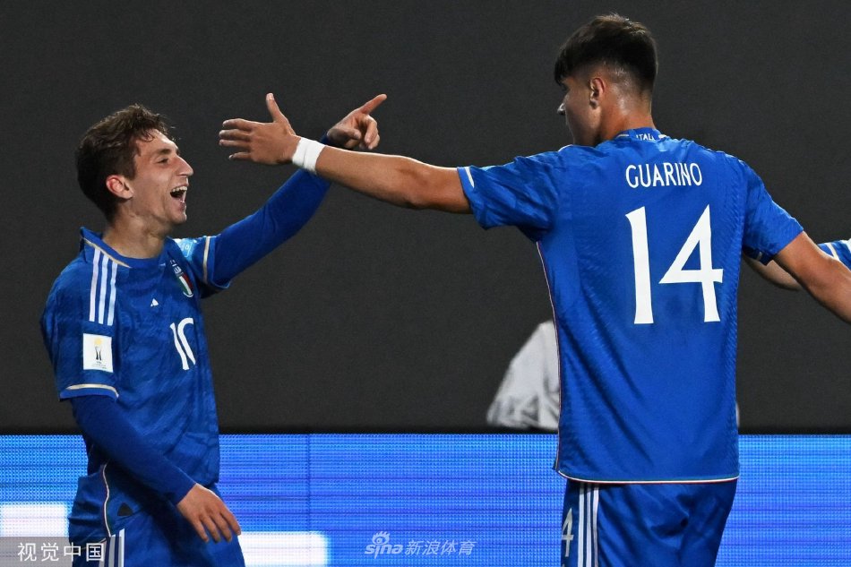 终场哨响，意大利队球员相拥庆祝胜利，蓝色身影在绿茵场上汇聚成欢乐的海洋。