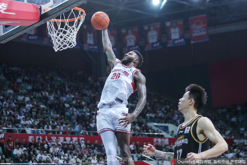 广州龙狮队球员陈盈骏在辽宁本钢队球员赵继伟的严密防守下，稳稳地持球组织进攻，眼神中透露着沉着与冷静。