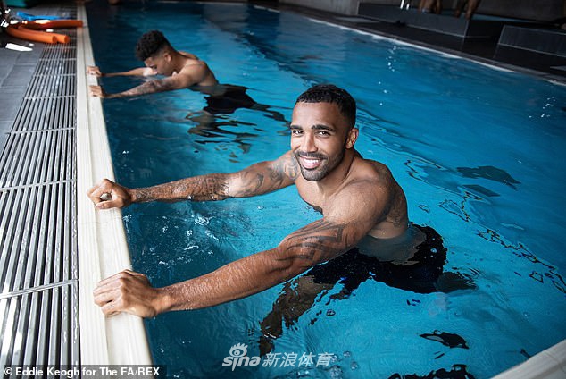 一名英格兰球员独自在水中进行拉伸，神情专注而放松，平静的水面映出他专注备战的身影，仿佛在进行一场身心的冥想。