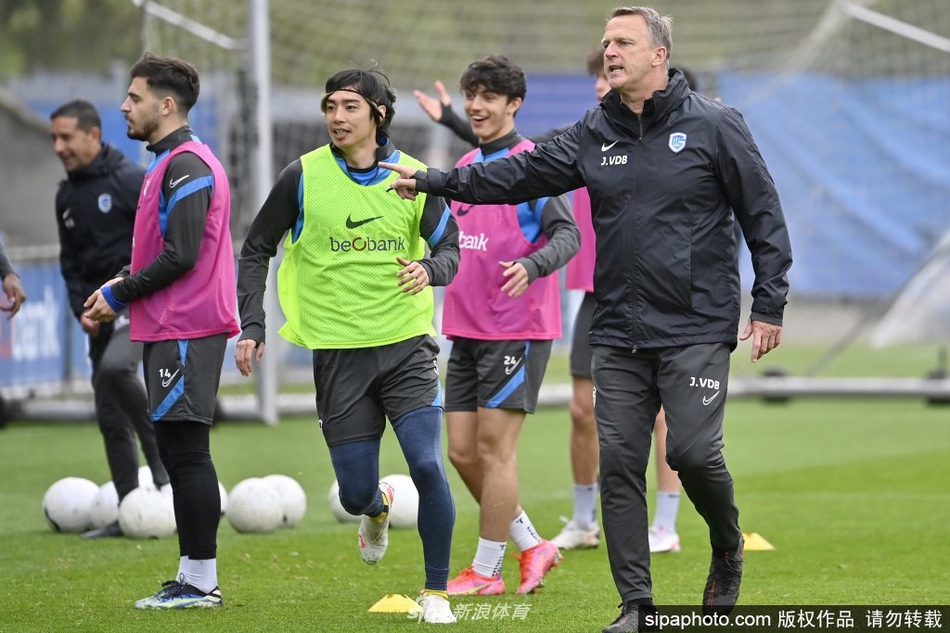 主教练在场边大声指挥，手势坚定，背景是看台上悬挂的巨幅球队队徽和标语。