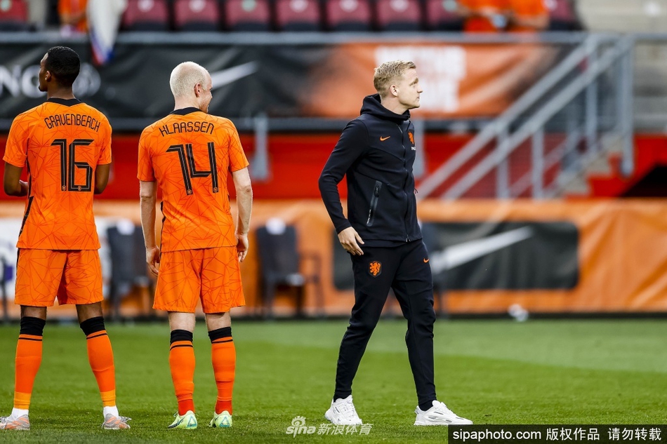 镜头拉近，范德贝克身穿橙色训练背心，脸上写满了不甘与无奈，眼神中透露出对大赛舞台的渴望与即将缺席的现实交织在一起的复杂情绪。