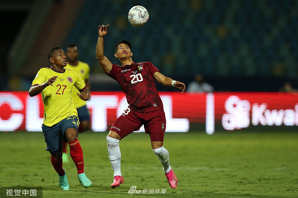 终场哨响，委内瑞拉球员们如释重负地拥抱在一起，庆祝这来之不易的一分，他们身披的白色战袍此刻宛如胜利者的铠甲；而哥伦比亚的夸德拉多则叉腰低头，凝视着草坪，满脸的不甘与无奈，形成一幅生动的绿茵悲喜图。