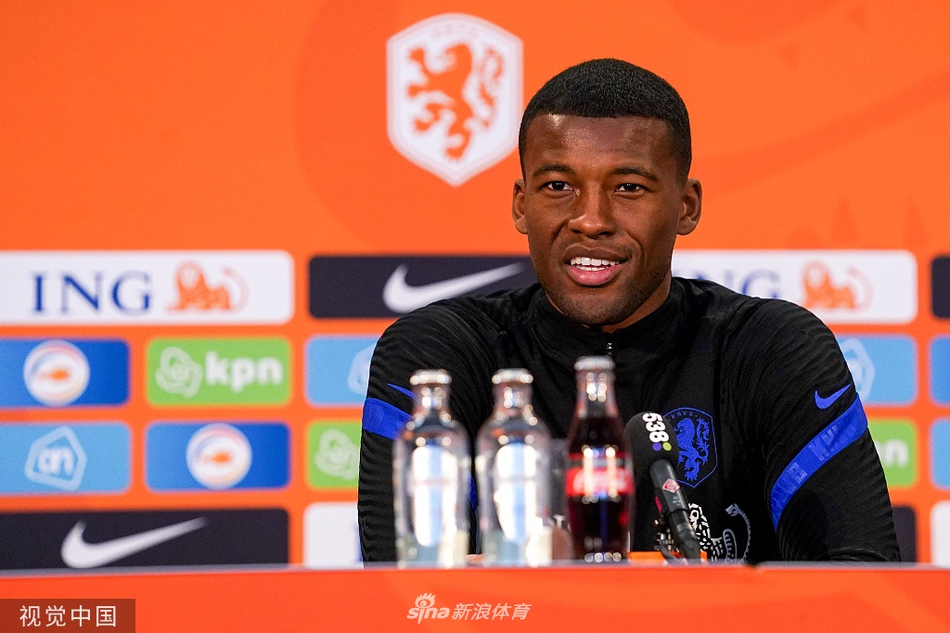 发布会结束后，荷兰队球员们神情轻松地起身离场，前景的话筒与背景中模糊的队徽交相辉映，预示着橙衣军团即将从发布厅走向真正的绿茵战场。