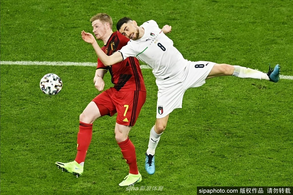 镜头聚焦在若日尼奥的面部特写，汗珠顺着他专注的脸颊滑落，眼神如鹰隼般锐利，正张开双臂指挥着身前的队友布防，仿佛一位战场上的将军在调兵遣将，将对手的进攻意图扼杀在萌芽状态。