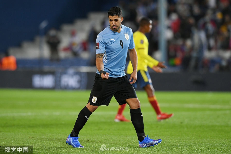 乌拉圭与哥伦比亚球员在中场展开激烈拼抢，扬起一片草屑