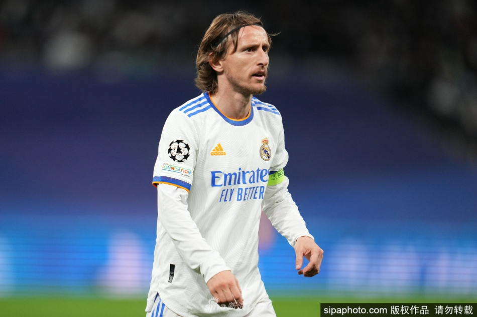 莫德里奇高举欧冠奖杯，与队友激情庆祝，笑容绽放荣耀之光