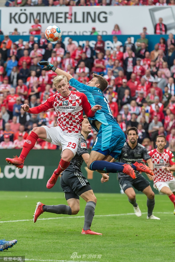 进球功臣马库斯·英瓦尔森在破门后激情挥拳庆祝，他身旁的美因茨队友们蜂拥而上，分享这宝贵的一刻。