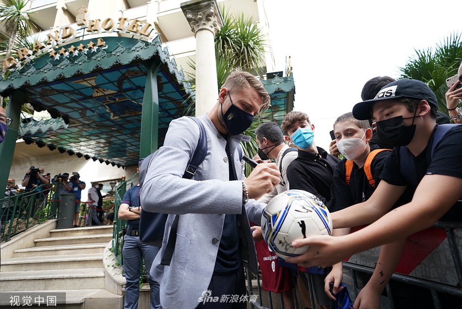 沉稳启航的背影：身着西装的多名意大利队员手提行李步入车站，他们的背影写满了专注与沉稳，蓝色征程由此开启。