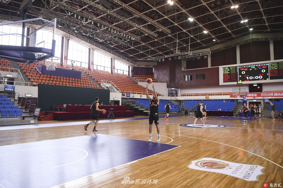 澳大利亚队员正进行绕桩折返跑冲刺，汗水如雨点般洒落，地板上的倒影与疾速的身影交织，仿佛已将赛场当成了狩猎的战场。