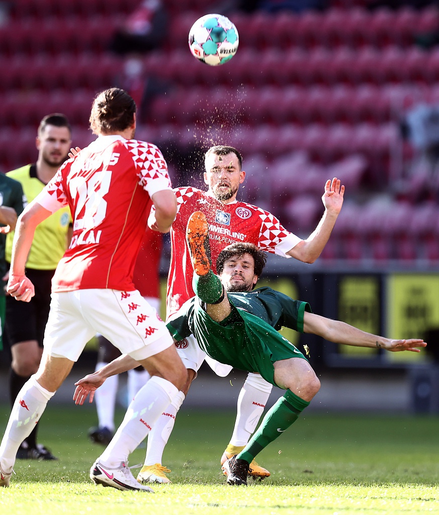 奥格斯堡队长豪韦勒乌眼神坚毅，与美因茨的施特格尔在中场展开一对一的强硬对话，手臂交错间展现出这场保级大战的原始火药味。