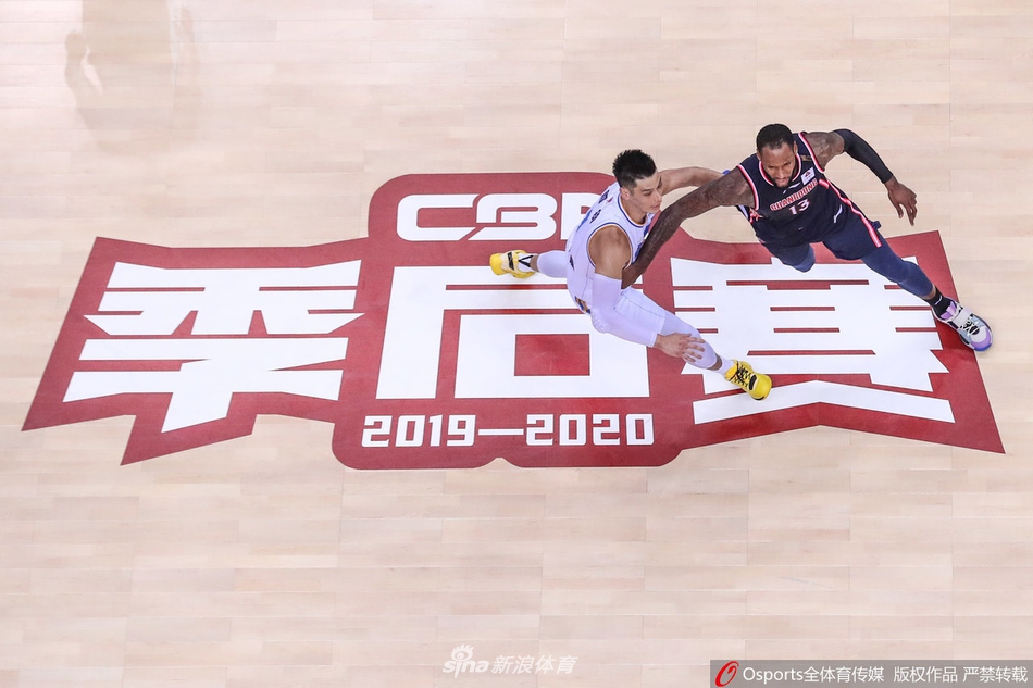 翟晓川在拼抢中摔倒在地，却依然死死将球抱在怀中，他的球衣沾满灰尘，眼神中透露着捍卫胜利的决心。