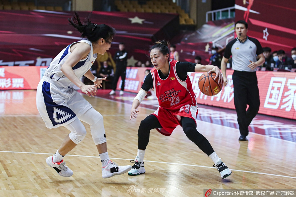 武汉女篮队员在新疆队高压紧逼下艰难运球突破，脸上写满了焦急与不甘，比赛强度可见一斑