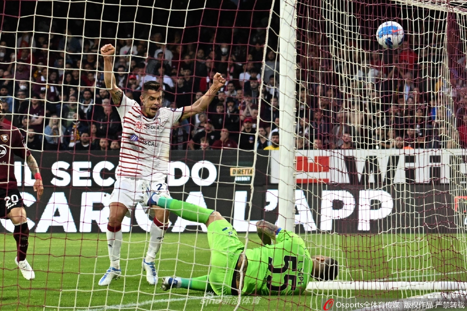 卡利亚里球员进球后张开双臂奔跑庆祝，背景是失落的萨勒尼塔纳后卫