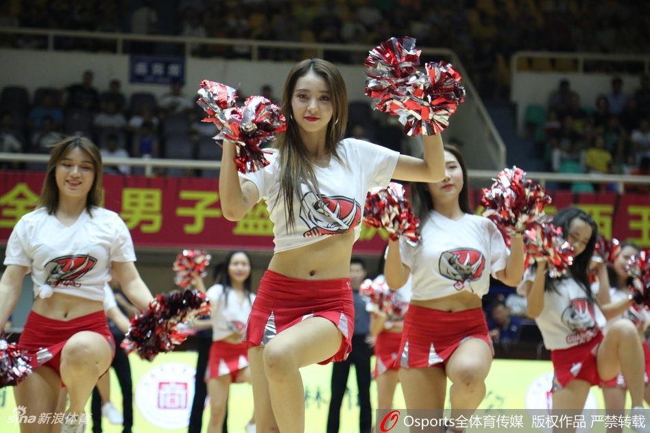 镜头定格在一位舞姿极具张力的啦啦队员身上，她高抬手臂，身姿挺拔，亮片装饰的队服在灯光下熠熠生辉，尽显青春活力与专业舞者的风采。