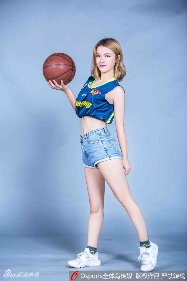 篮球宝贝倚靠在栏杆边,身着广东队球衣,眼神深邃,气质温婉动人