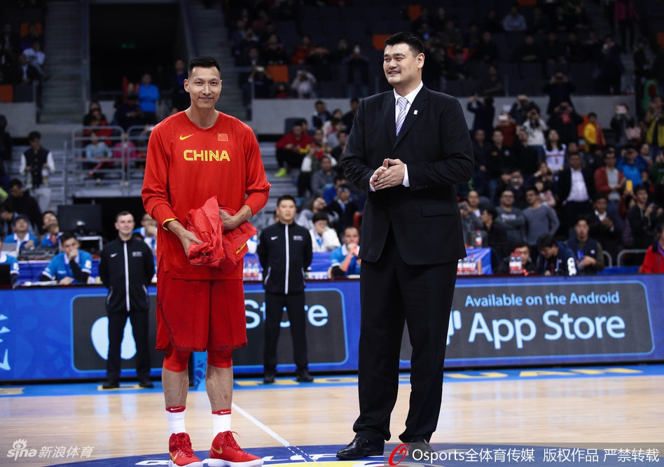 姚明与易建联在场上并肩而立，两人的身影在灯光下被拉长，姚明侧身对着阿联叮嘱着什么，阿联认真倾听，画面里仿佛流淌着中国男篮两大内线传承的温情与厚重。