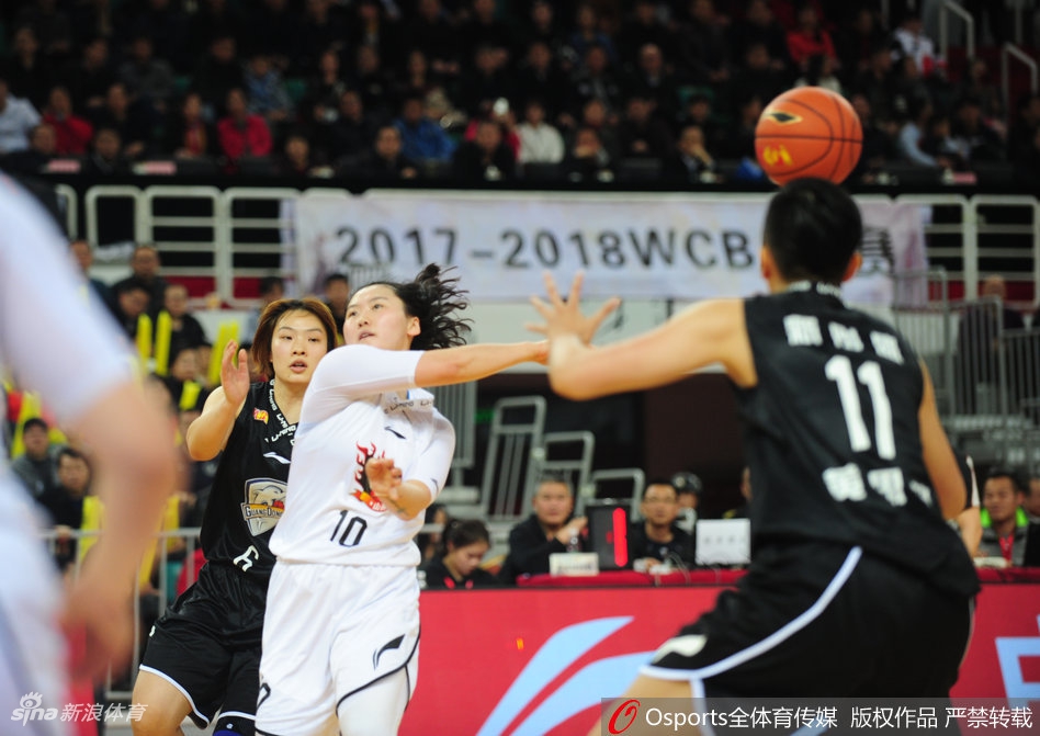 广东女篮核心杨力维运球组织进攻，她眼神坚定试图加速摆脱山西队防守球员，但山西队的防守阵型保持得极为严密