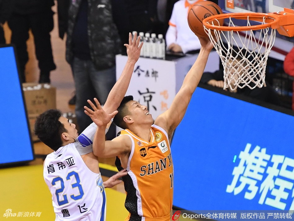 暂停时刻，江苏肯帝亚的替补席气氛凝重，主教练贝西诺维奇手持战术板躬身部署，球员们聚精会神聆听，大战的紧张感在这一刻凝固。