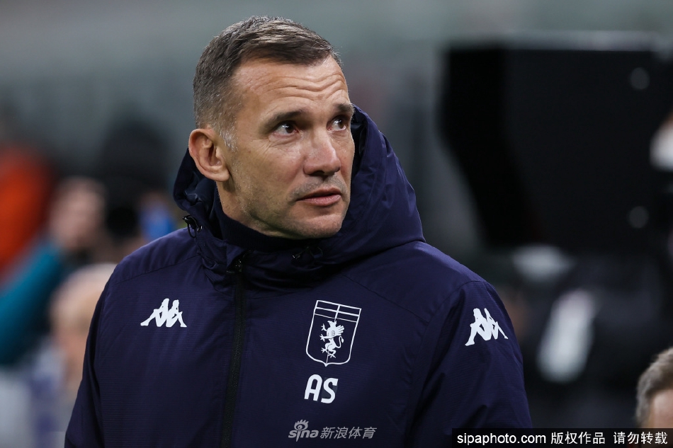 舍甫琴科站在球场边线，全神贯注指挥比赛，双手挥舞进行战术部署，背景是热那亚队正在场上奋力拼搏