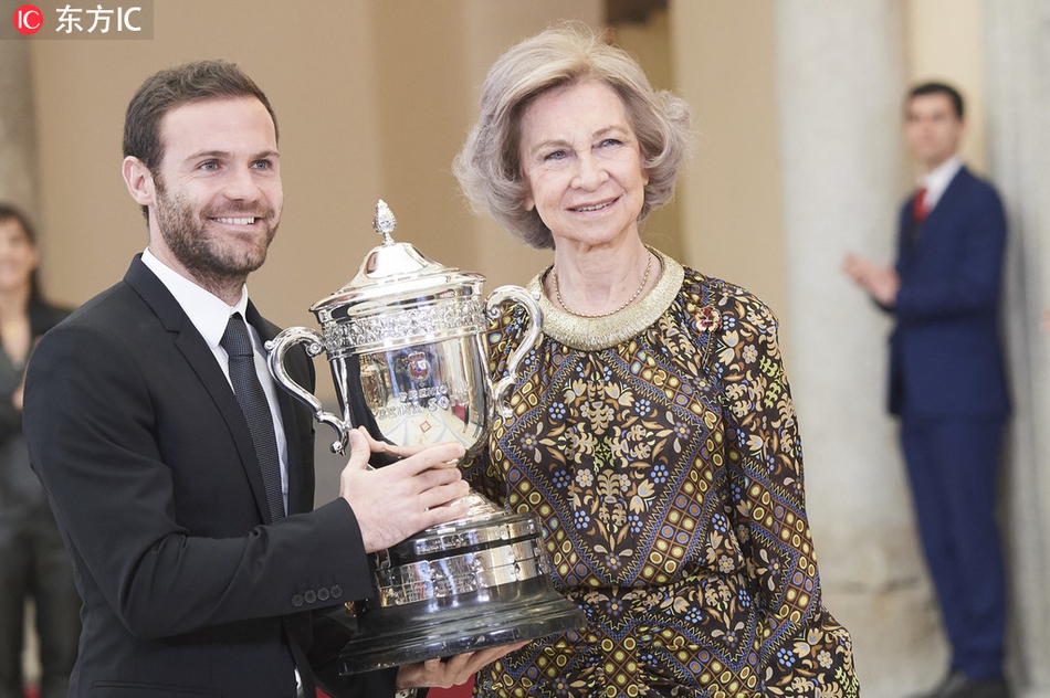 手捧奖杯的马塔在后台与家人分享喜悦，他微微侧身，让奖杯的光泽与家人的笑容同框，这一刻的温情与荣耀，属于他们共同拥有。