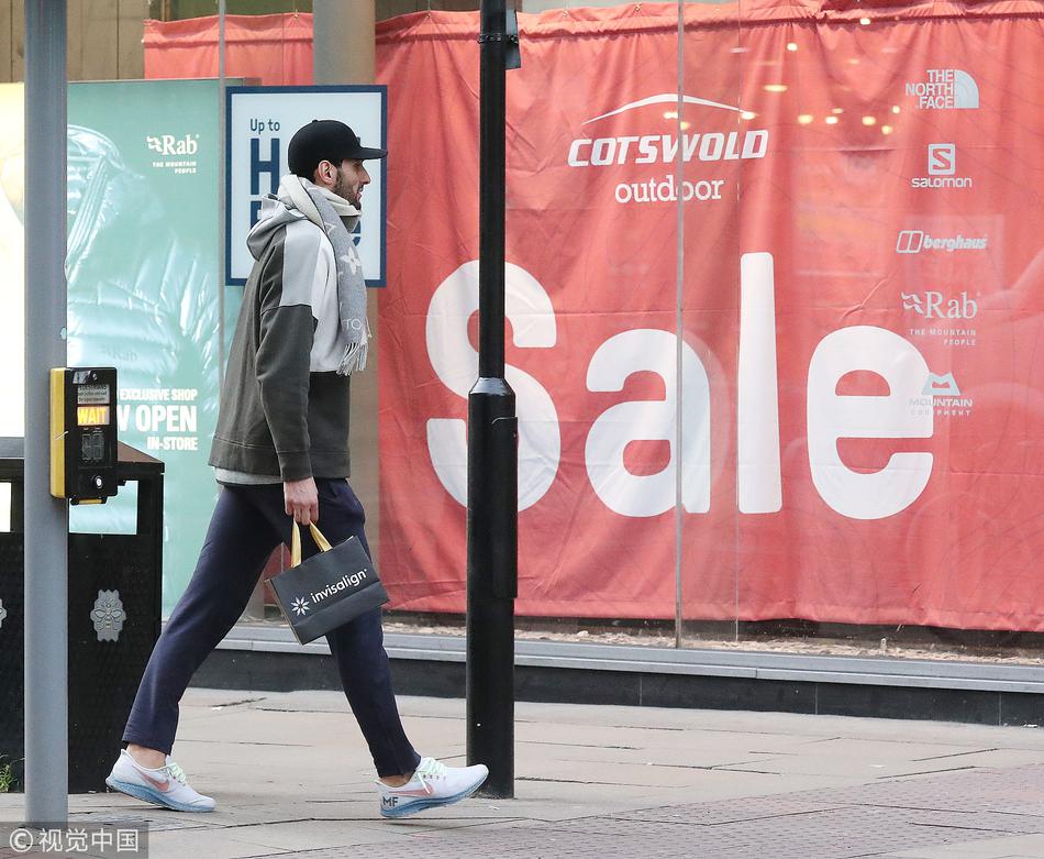 冬日的曼彻斯特街头，费莱尼身穿一件厚实的黑色长款羽绒服，将自己裹得严严实实，他肩背黑色双肩包，双手插兜，眼神放空地望向前方，那标志性的爆炸头像一簇沉默的火焰，在灰蒙蒙的天空下显得格外落寞。