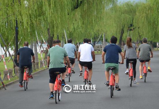 马克里总统一行在西湖边骑行游览。