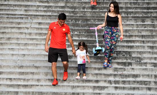 这是马丁内斯（左）与家人散步。新华社记者杨文斌摄