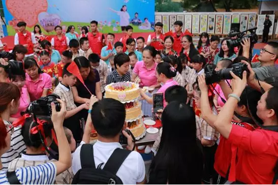 南宁市社会福利院的开放日活动中，孩子们一起分享节日蛋糕。