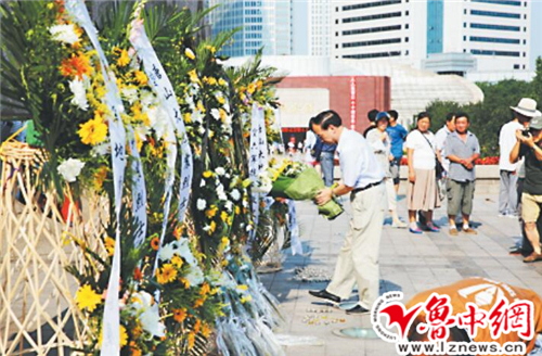 28日，市民在抗震纪念碑前献花。