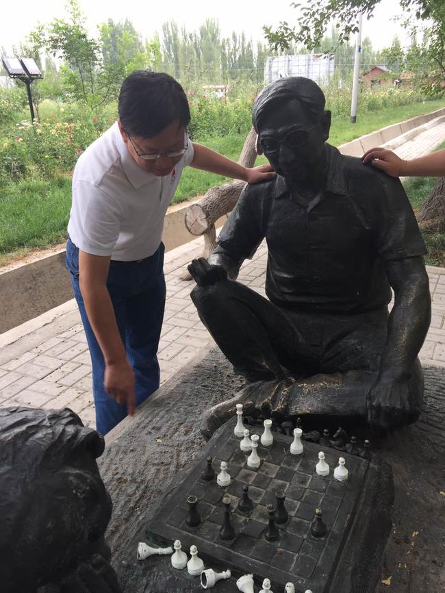 叶江川在霍城国际象棋雕像前合影