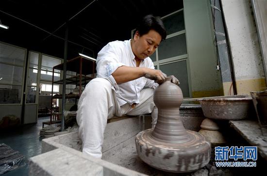 崔涛在拉坯，准备手工制作耀州窑青釉剔花倒装壶（7月10日摄）。