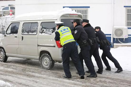 民警們齊心協(xié)力幫司機推車。
