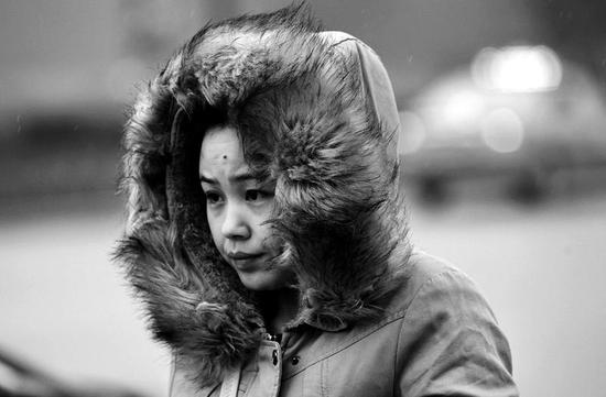 昨日，西安市下起了雨，氣溫也下降了許多，街頭的行人穿起了冬裝    實(shí)習(xí)記者陳飛波攝