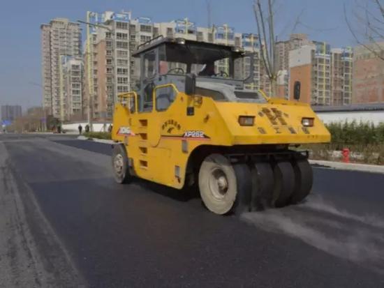 |3月8日下午，市政工作人員對開元路進行瀝青面層鋪筑。|