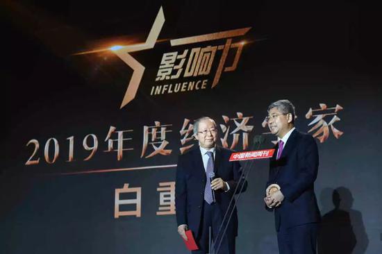 中国经济体制改革研究会会长、国家发展和改革委员会原副主任彭森（左）为白重恩（右）颁发荣誉