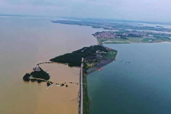 江西鄱阳湖东岸,一侧为清澈的鄱阳湖内湖珠湖,一侧为因暴雨变浑浊的鄱阳湖外湖。|央视新闻