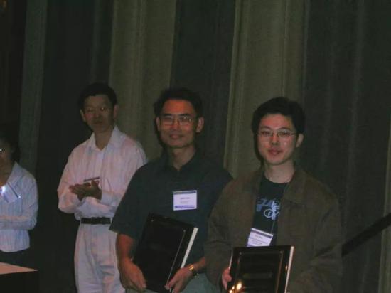 2005 年楊強（右二）KDD Cup 奪冠照片，右一為沈抖