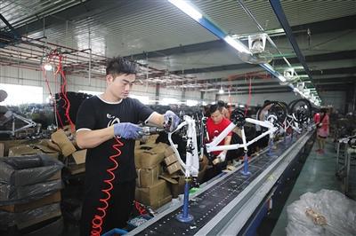 8月12日，王庆坨镇一代工加工厂内，工作人员正在组装自行车，负责人介绍，厂内只留下一条生产线来进行组装加工。
