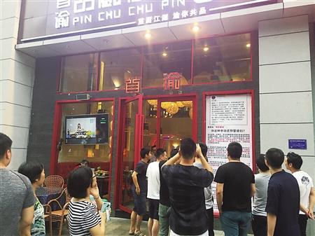 餐馆门口张贴的千字海报引路人围观 记者 张宇 摄