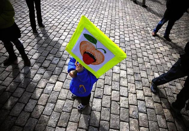 在保加利亚的一场示威游行中，一名儿童手举反转基因作物的海报。| 来源：Vassil Donev/EPA/Shutterstock