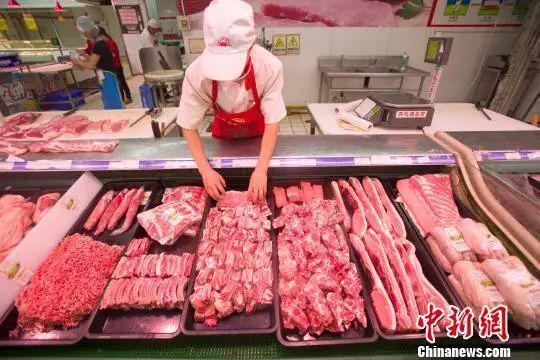 资料图:山西太原,超市员工在整理猪肉。张云 摄