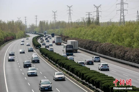 资料图：某高速路段，过往车辆川流不息（图文无关）。 图片来源：视觉中国