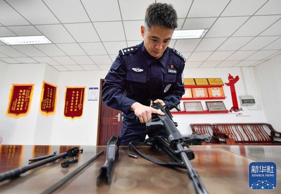 在天津市公安局河东分局巡特警支队二大队驻地，李欢在对巡逻配枪进行装卸