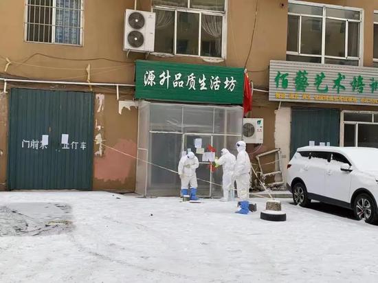 在通化市源升品质养生坊门外,几名疾控部门工作人员正在工作。